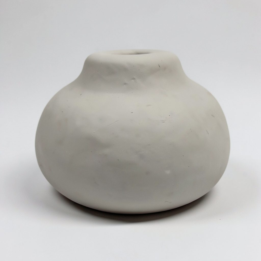 Soft clay-model render of rounded handmade abstract seating forms arranged in a cluster, in muted charcoal and plum tones with warm gold highlights, evoking a quiet conference breakout space.